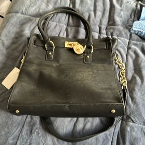 Black leather Michael Kors. Never used however I did get it through Poshmark